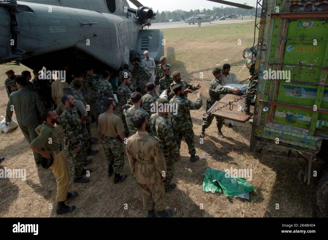 US Navy  Pakistani soldiers load relief supplies on a U.S. Navy MH-53E Sea Stallion helicopter. Stock Photo