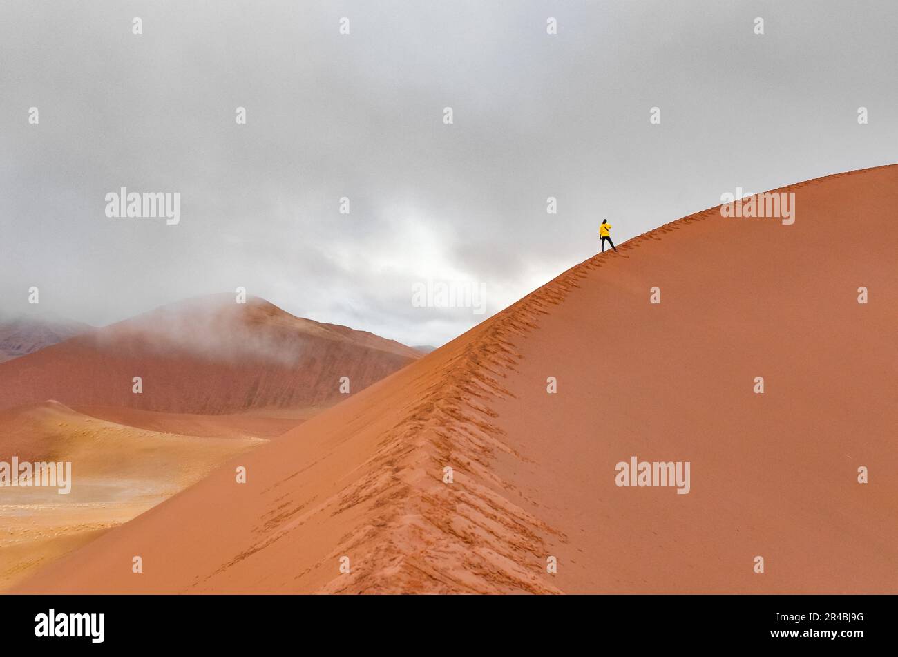 Woman tourist walking on beautiful sunrise red sand dunes, african ...