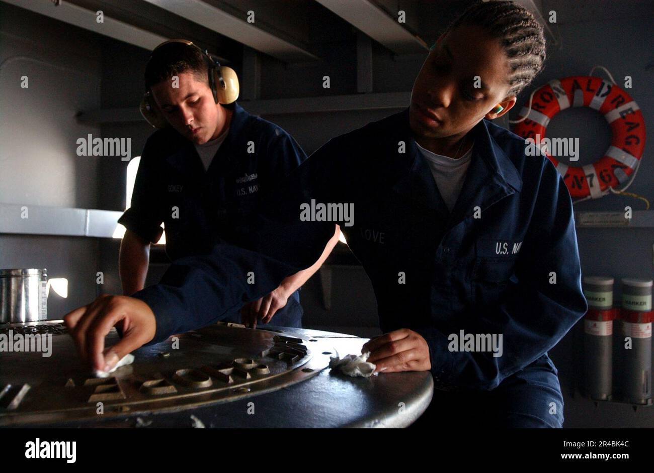 US Navy Seaman right, and Boatswain's Mate polish brass on a capstan ...