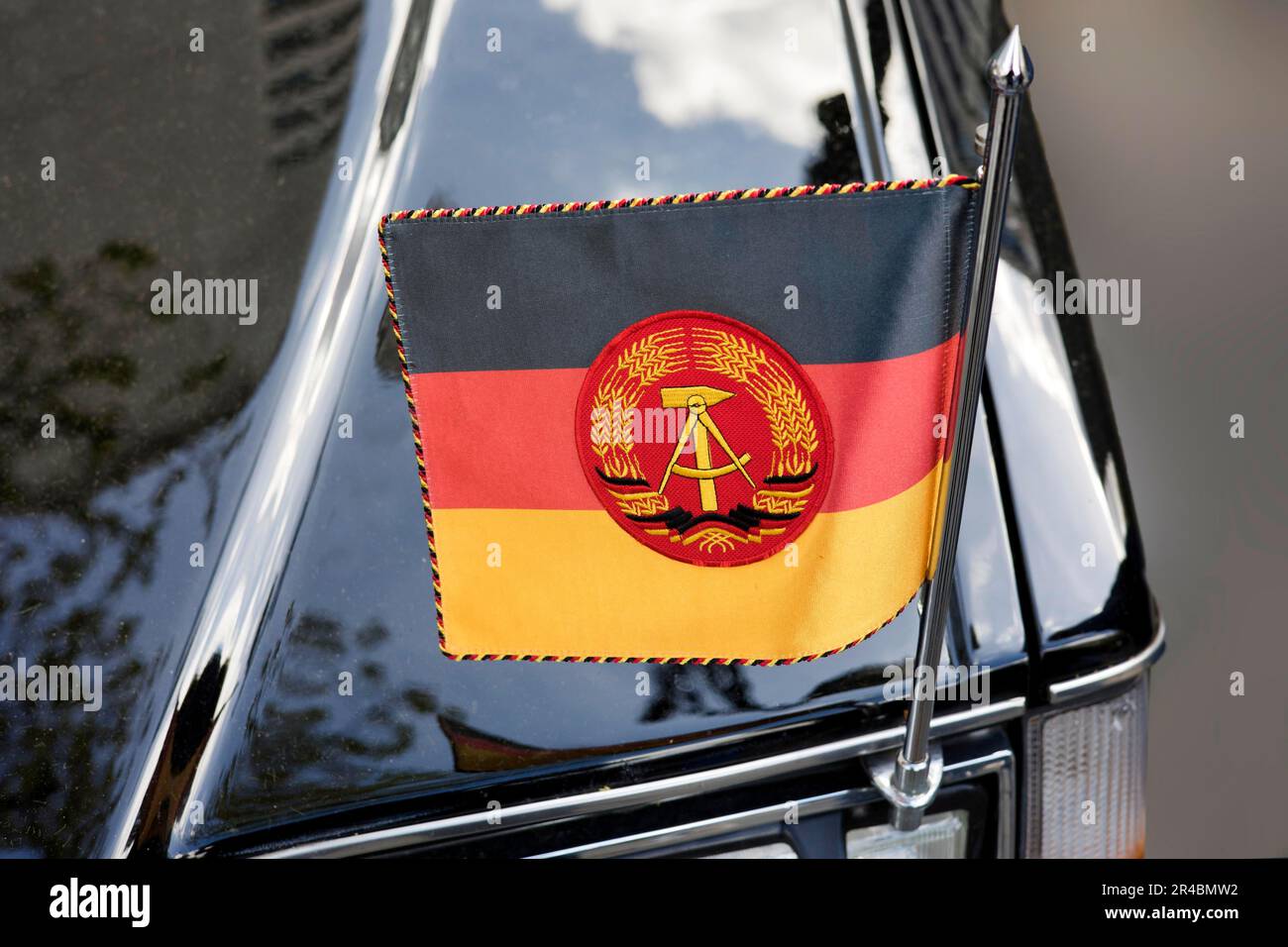 National flag of the GDR on a state coach Volvo 264 TE, Classic Days, Berlin, Germany Stock Photo