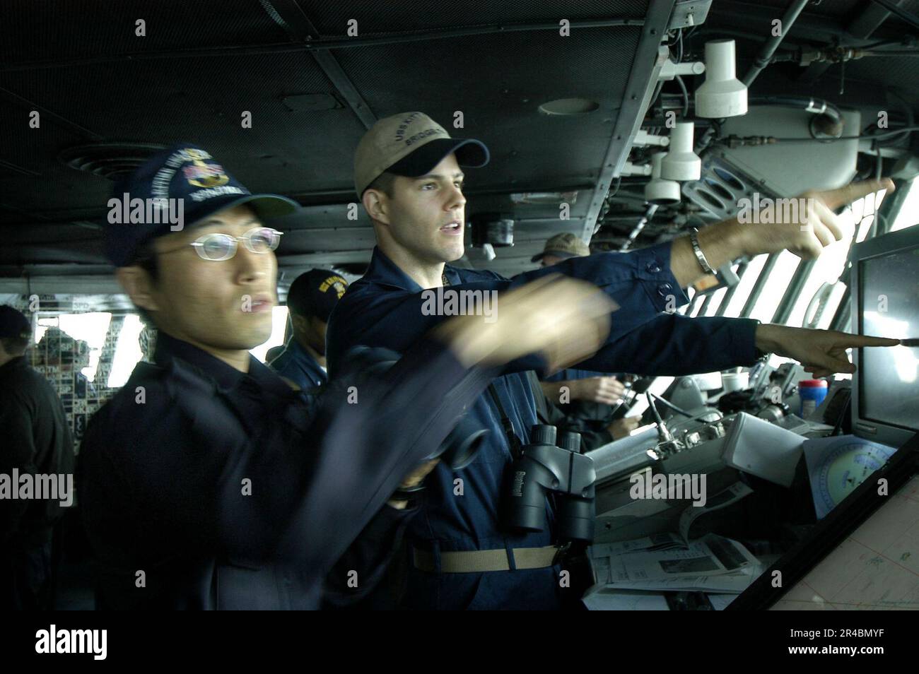 US Navy  U.S. Navy Lt.j.g. right, and Japan Maritime Self-Defense Force (JMSDF) Lt. work together to establish ship alignment during Annual Exercise. Stock Photo