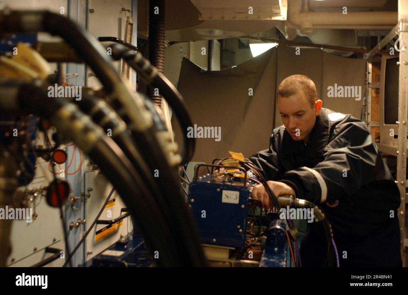 US Navy Aviation Electronics Technician 2nd Class connects radio