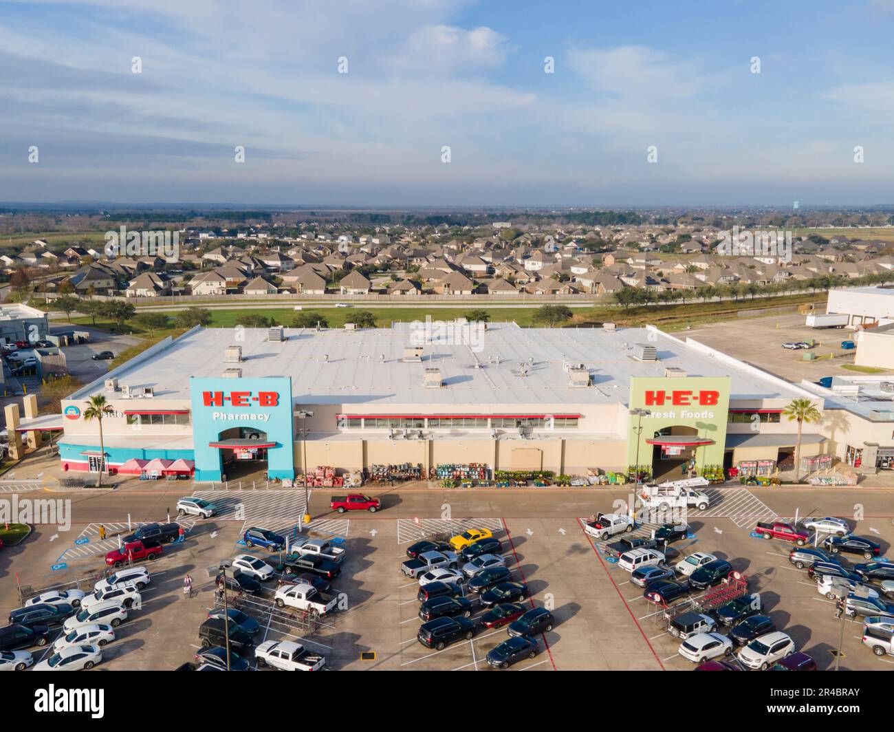 An aerial view of HEB Grocery Store in League City, Texas with cars
