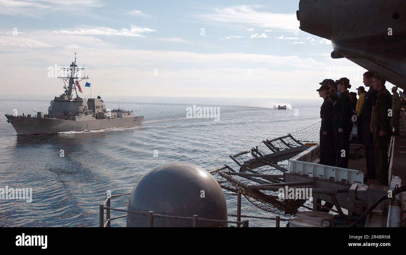 US Navy Along the edge of the flight deck of amphibious assault ship ...