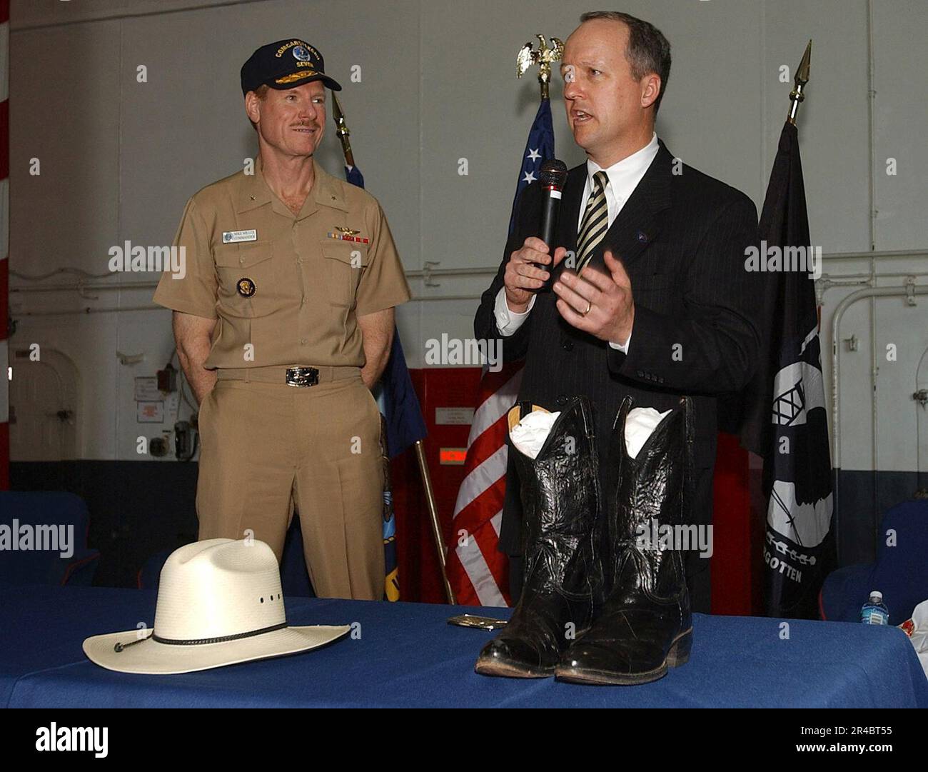 US Navy  Executive Director of the Ronald Reagan Presidential Library, Duke Blackwood, right, explains the history of a pair of boots and cowboy hat worn by President Ronald Reagan. Stock Photo
