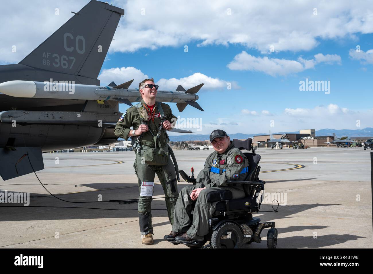 U.S. Air Force Capt. John Toliuszis, F-16 pilot from the 120th Fighter  Squadron, talks with Jeremiah Price, the Wish recipient, about his flight  at Buckley Space Force Base, Colorado, March 31, 2023..