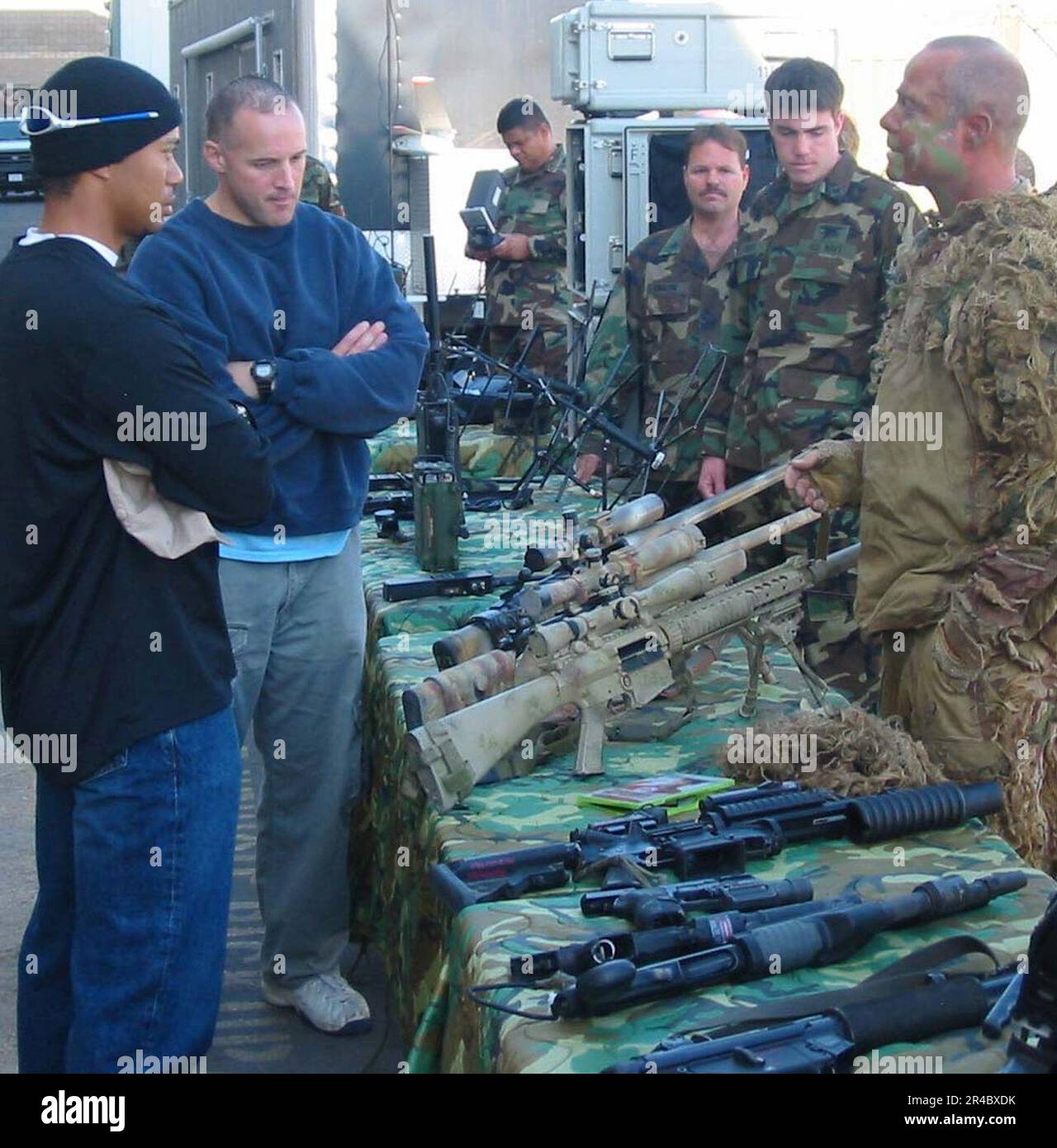 US Navy Pro golfer Tiger Woods views a static display of various SEAL