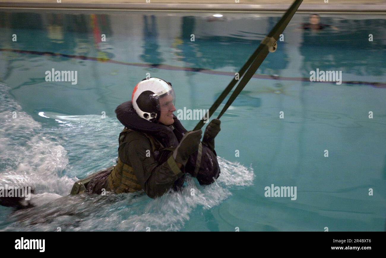 US Navy  Driver of the Navy sponsored NASCAR Busch series number 88 car, completes the parachute drag during survival training at the Aviation Survival Training Center onboard Naval Air Station. Stock Photo