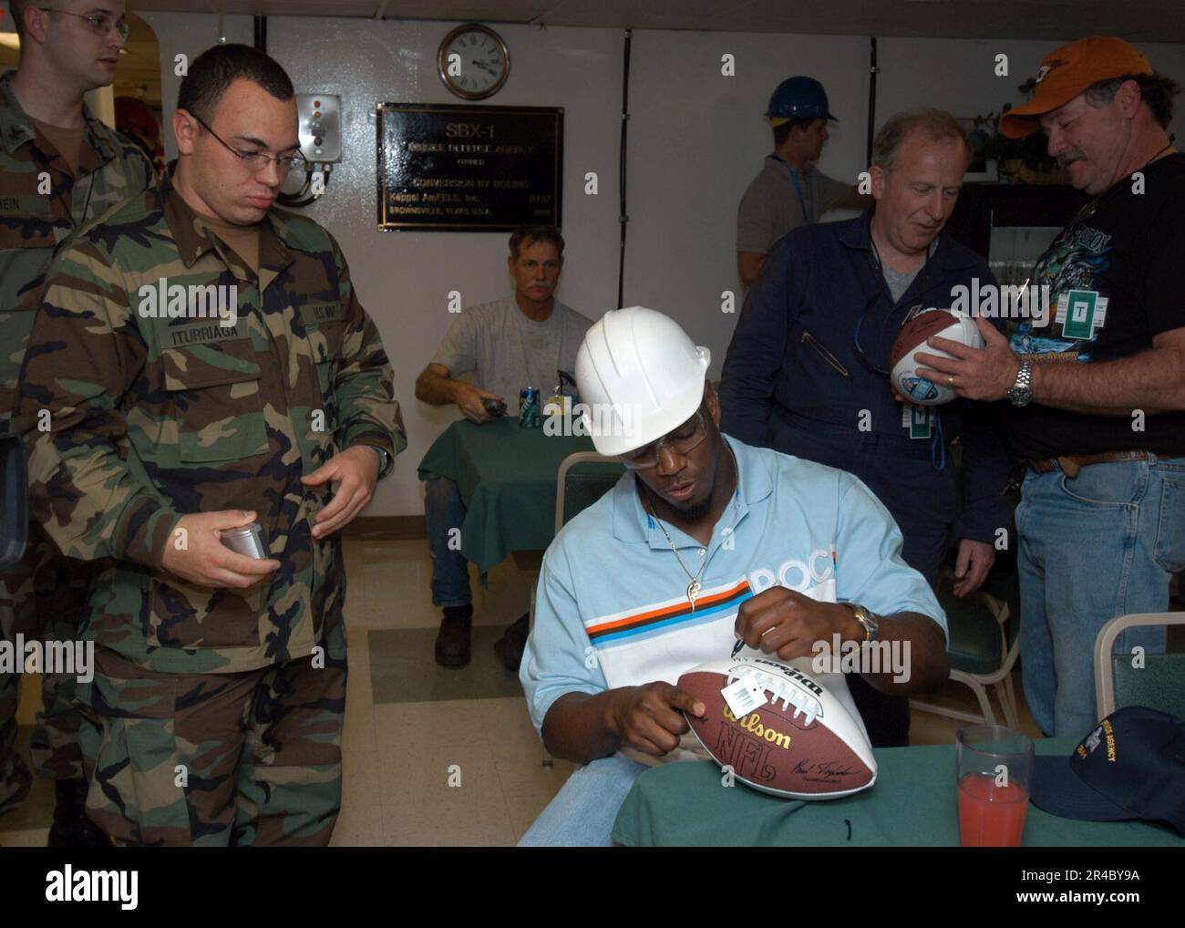 US Navy  National Football League (NFL) New York Jets' linebacker, Jonathan Vilma, signs autographs for Sailors assigned to Amphibious Construction Battalion Two (ACB-2). Stock Photo