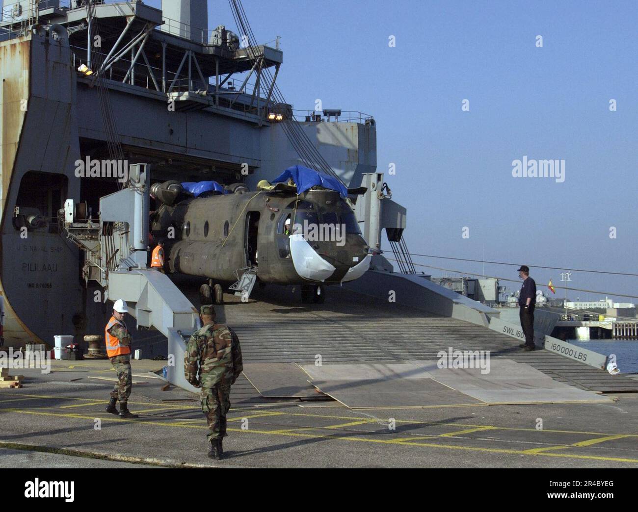US Navy  A U.S. Army CH-47 Chinook helicopter is offloaded from the Military Sealift Command (MSC) roll-on-roll-off ship USNS Pililaau (T-AKR 304). Stock Photo