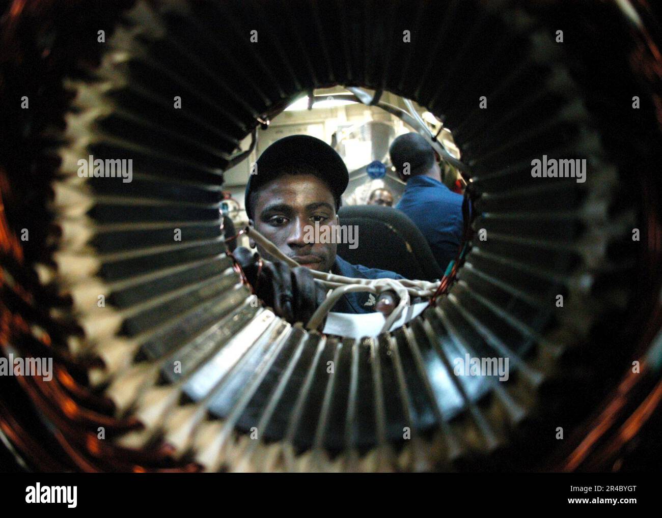 US Navy Electrician's Mate 3rd Class checks the connections on an