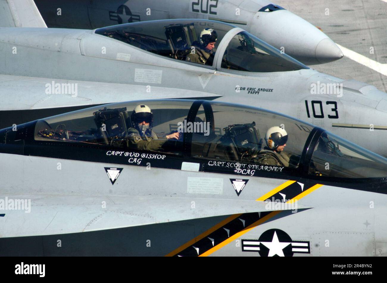 US Navy  Pilots assigned to Strike Fighter Squadron One Zero Three (VFA-103), and Fighter Squadron One Four Three VFA-143, prepare to taxi to the catapult for take off from the flight deck. Stock Photo
