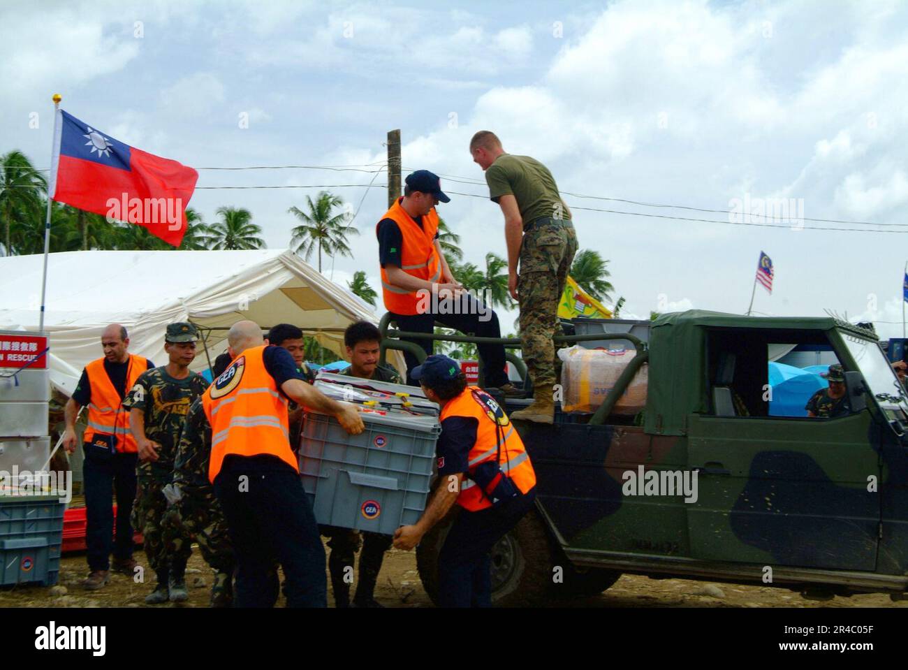 US Navy  Philippine Army and Turkish rescue workers unload a vehicle filled with relief supplies during rescue efforts following a devastating landslide that struck southern Leyte on Feb. 17, 2006. Stock Photo