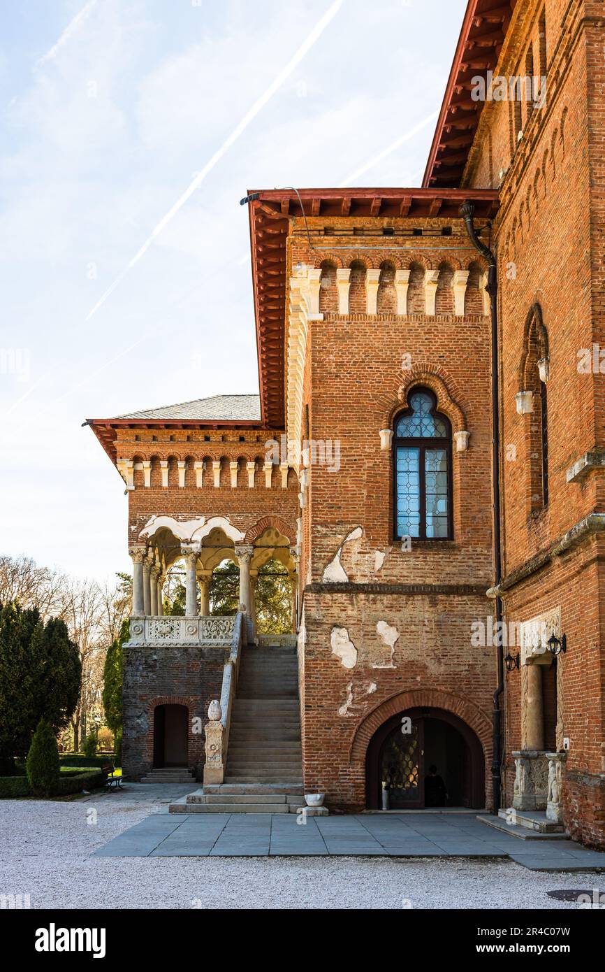 An elegant red brick building with a plethora of windows and a set of ...