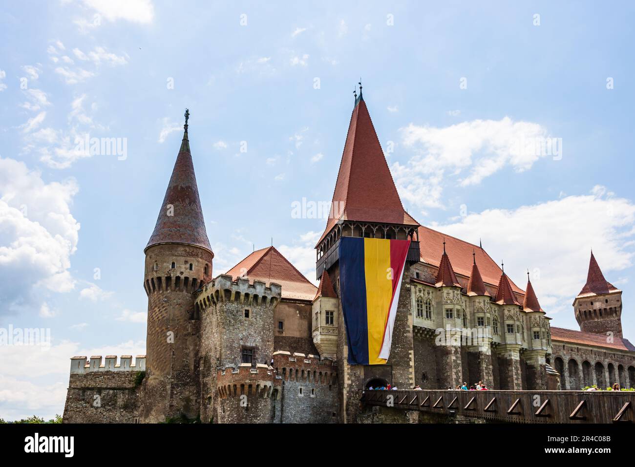 A grand castle stands majestically on the edge of a tranquil lake ...