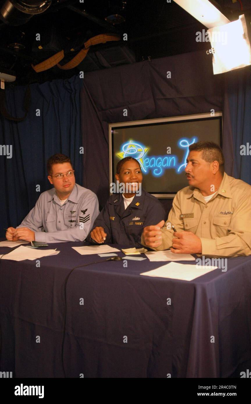 US Navy Photographer's Mate 1st Class left, Chief Warrant Officer