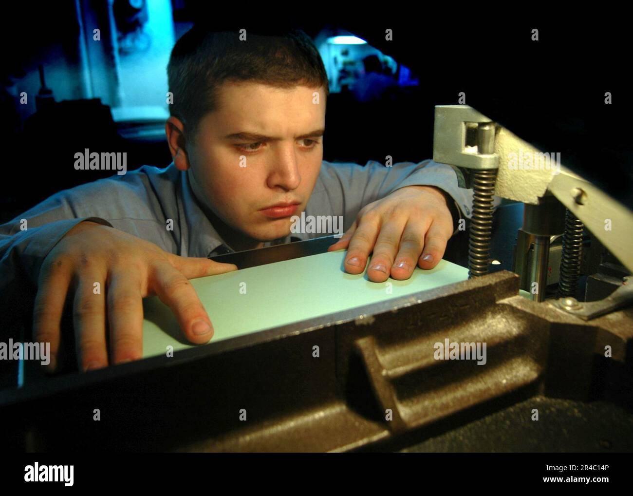 US Navy Lithographer's Mate Seaman uses a Challenge Paper Driller to