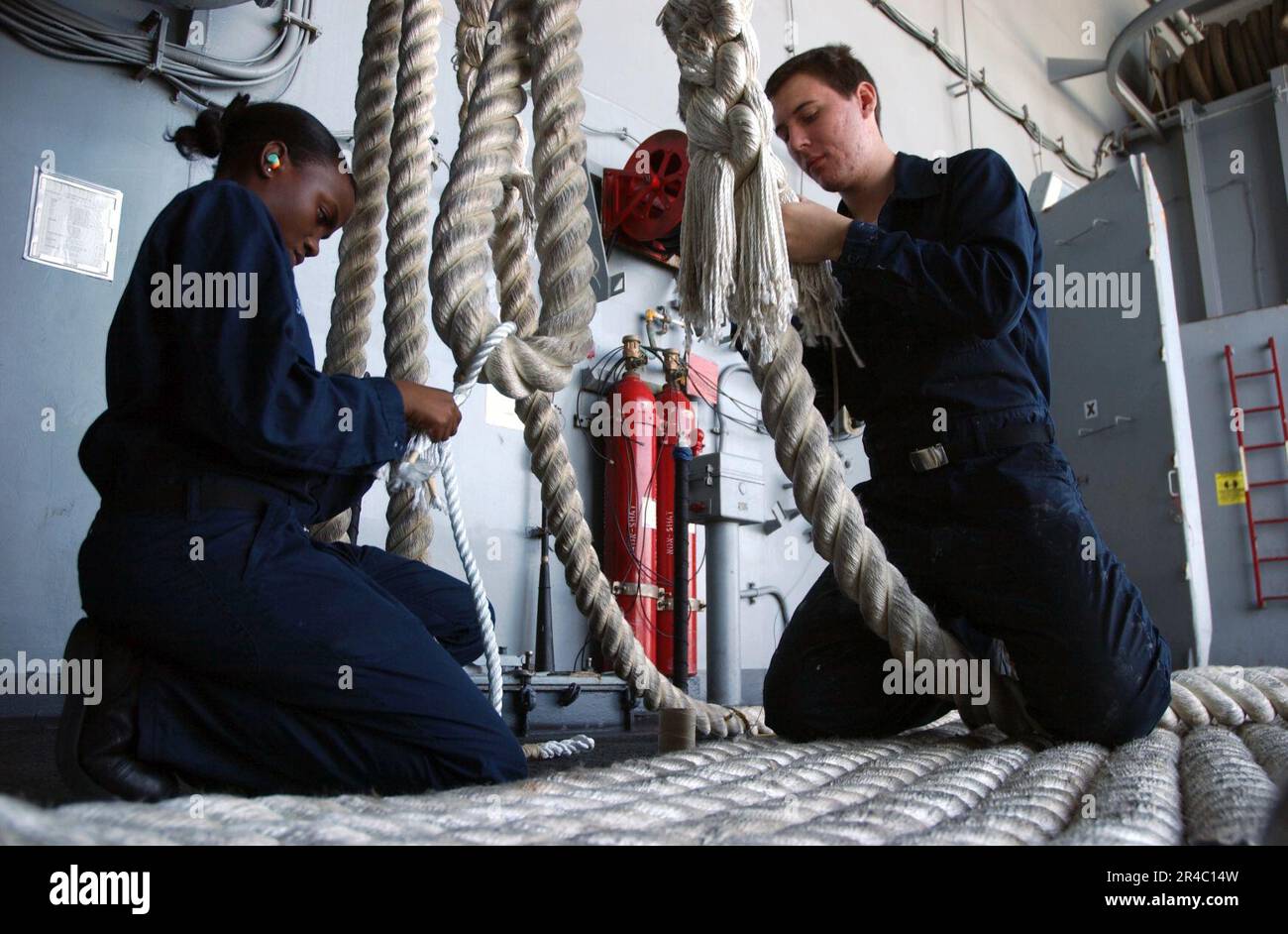 US Navy Boatswain's Mate 3rd Class left, and Seaman right, finish
