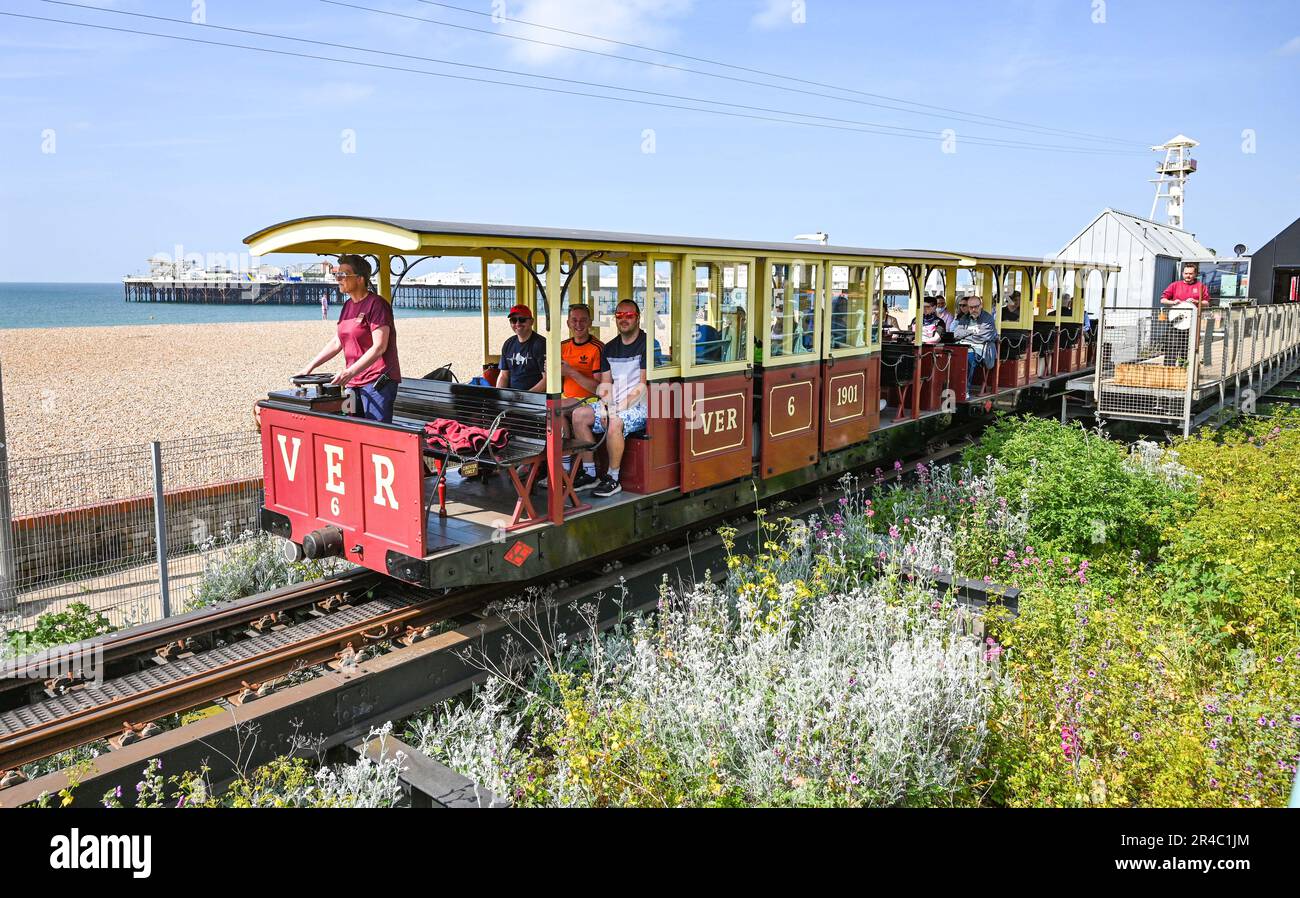Brighton UK 27th May 2023 - Visitors enjoy a ride on the Volk's Railway along Brighton seafront in the bank holiday weekend sunshine which is forecast for most of the UK over the next few days : Credit Simon Dack / Alamy Live News Stock Photo