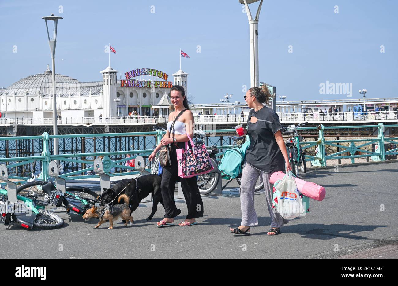 Brighton UK 27th May 2023 - Visitors enjoy a stroll in the bank holiday weekend sunshine on Brighton seafront which is forecast for most of the UK over the next few days : Credit Simon Dack / Alamy Live News Stock Photo