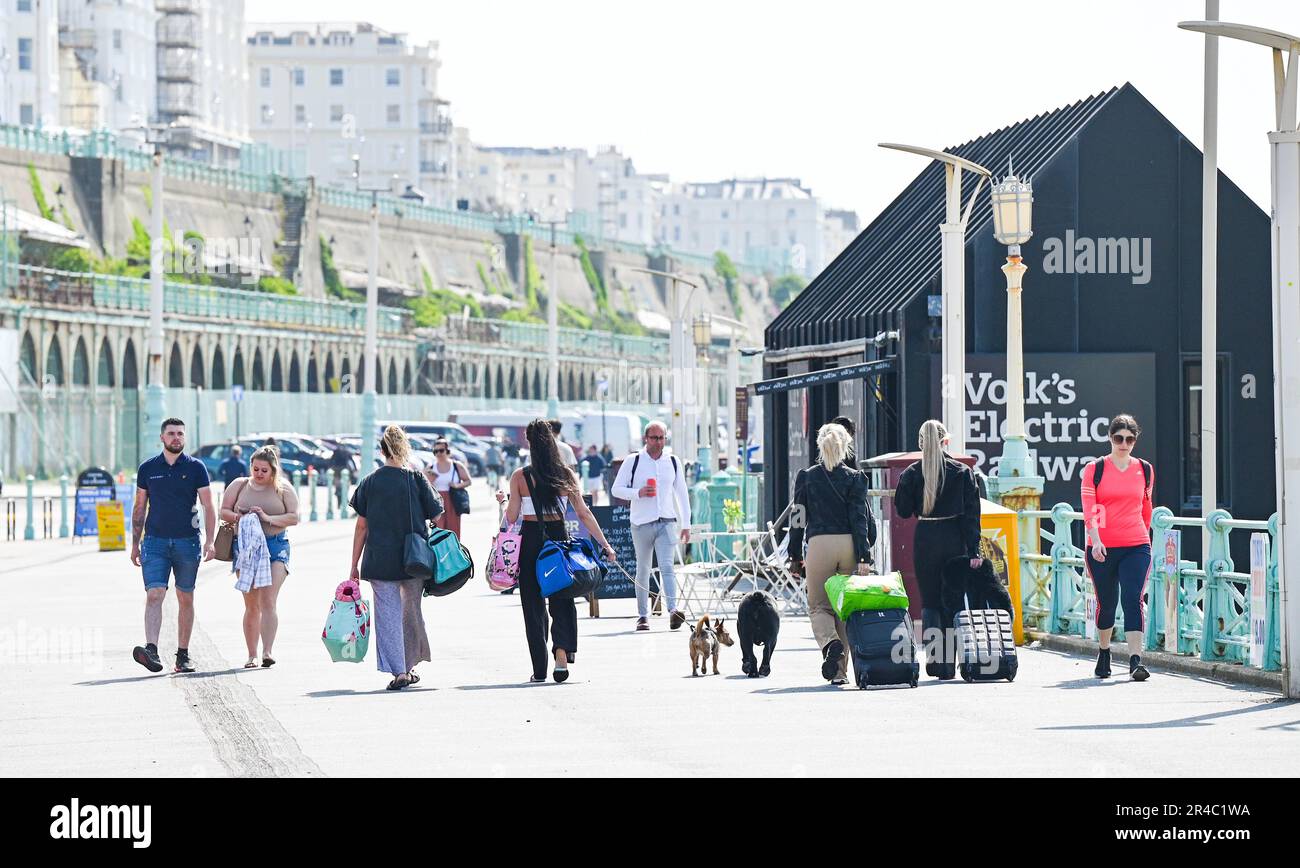 Brighton UK 27th May 2023 - Visitors start to arrive on Brighton seafront as they enjoy the bank holiday weekend sunshine which is forecast for most of the UK over the next few days : Credit Simon Dack / Alamy Live News Stock Photo