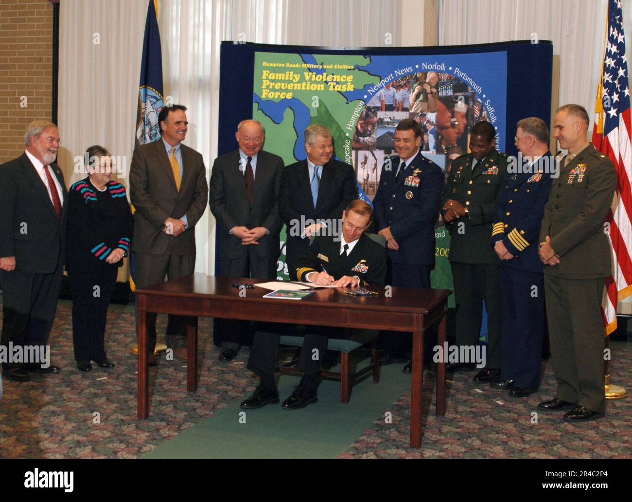 US Navy Rear Adm. Frederic Ruehe, signs a memorandum of understanding ...