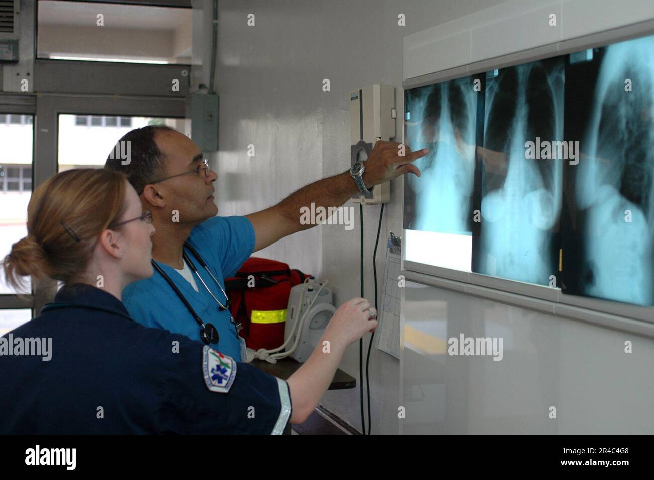 3rd Digit X Ray Routine US Navy Navy Hospital Corpsman 3rd Class and Lt. discuss a patient's X ...