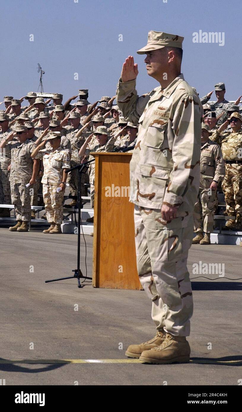 US Navy  U.S. Navy Rear Adm. Richard W. Hunt salutes the Ensign during the playing of the National Anthem at the conclusion of the Combined Joint Task Force, Horn of Africa (CJTF HOA) change of command ceremon. Stock Photo