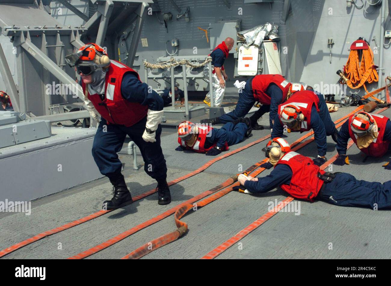 US Navy Sailors react to a crash and salvage drill aboard the guided ...