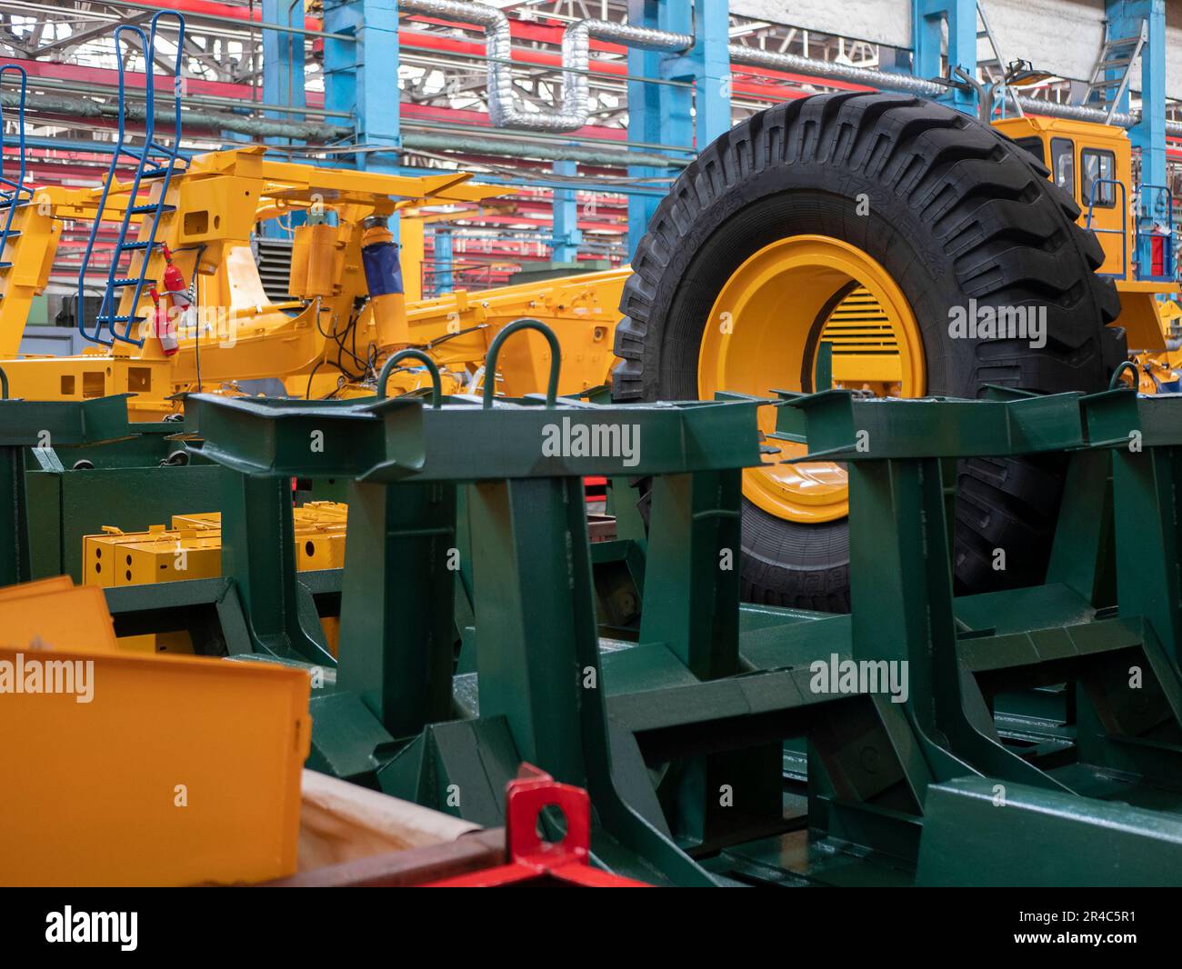 Workshop of machine-building plant, selective focus. Huge wheel and different metal components and assemblies Stock Photo