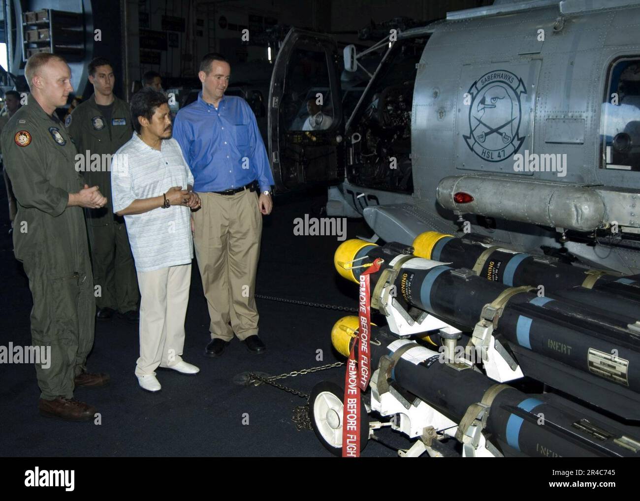 US Navy  His Royal Highness, Prince Mohamed, Foreign Minister of Brunei, and Charge D' Affaires of Brunei Jeff Hawkins, are given a tour of an SH-60B Seahawk. Stock Photo