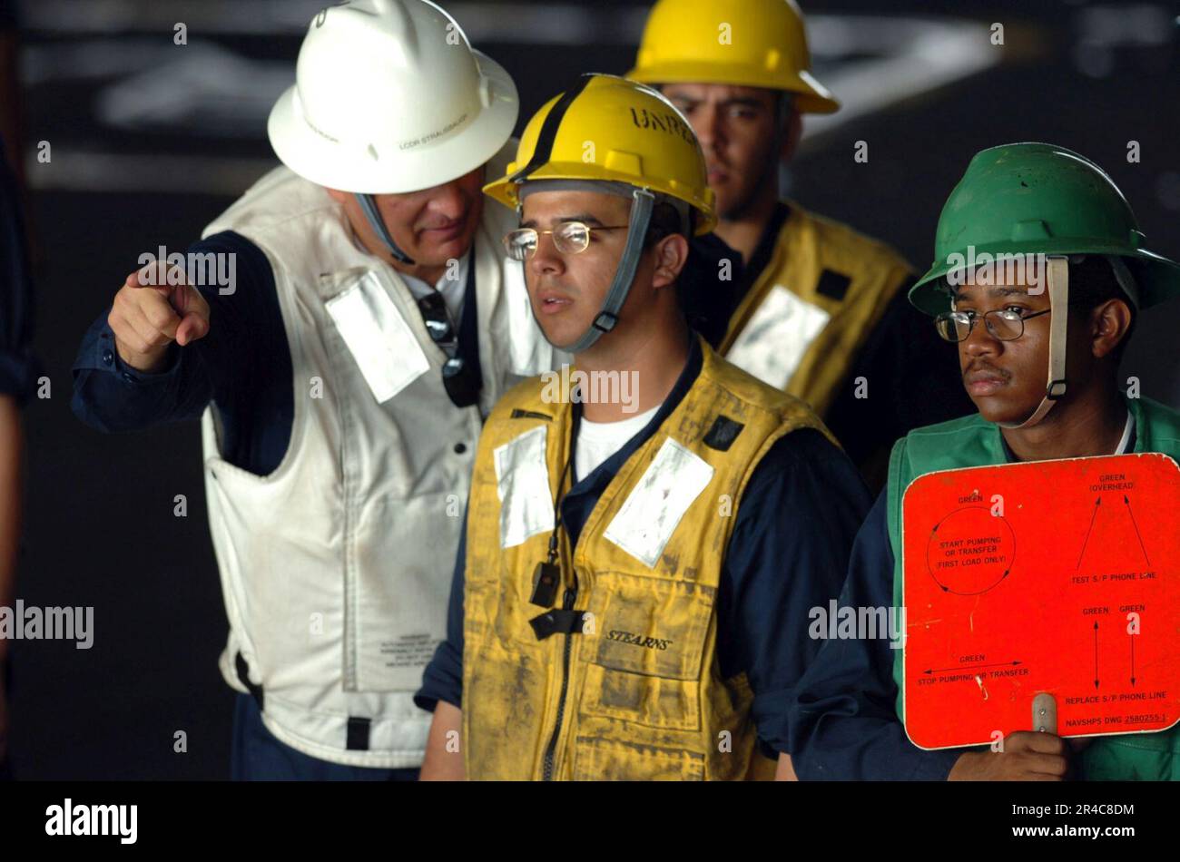 US Navy Lt. Cmdr. gives direction to Rig Captain, Boatswain's Mate 3rd ...