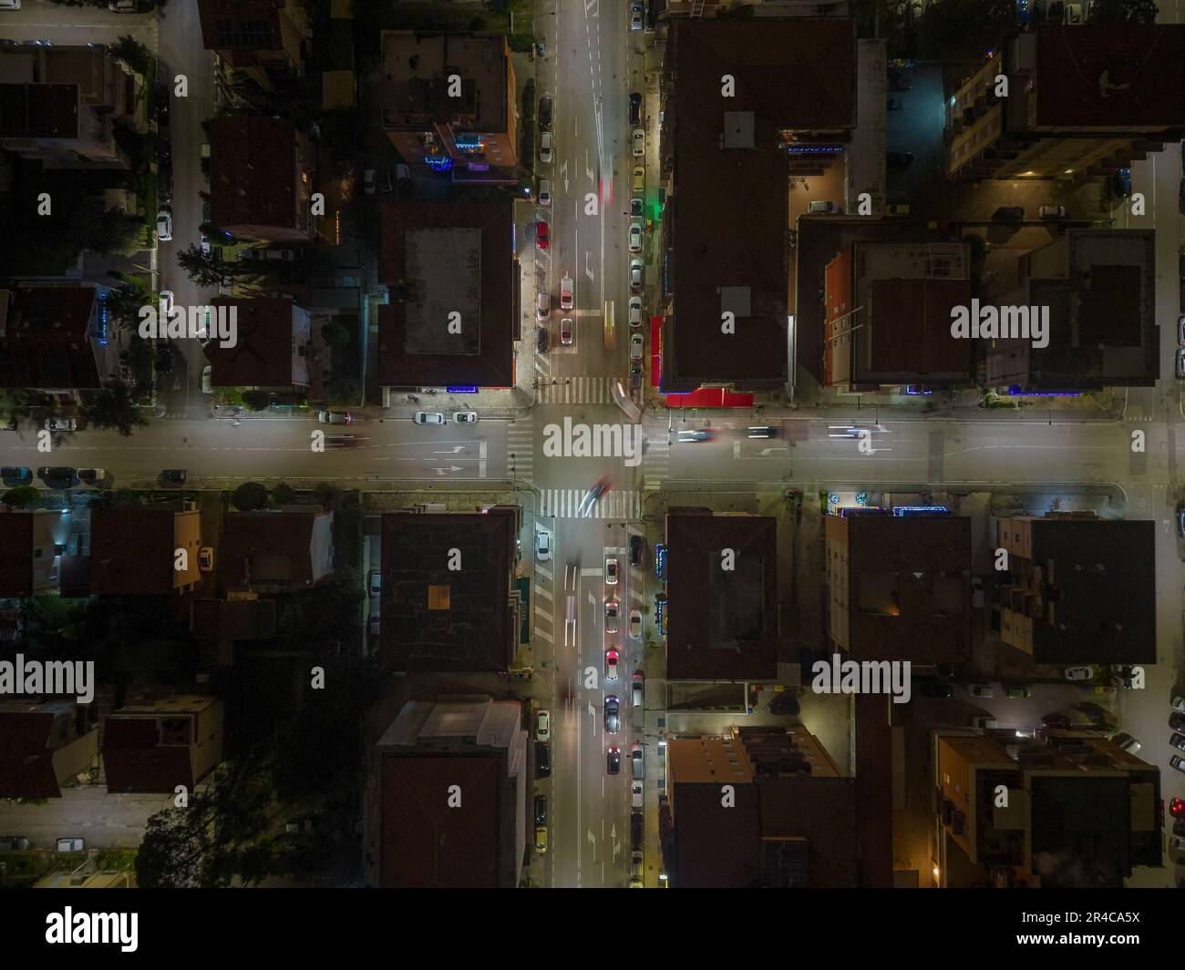 An aerial view of a city skyline at night, illuminated by the lights of ...