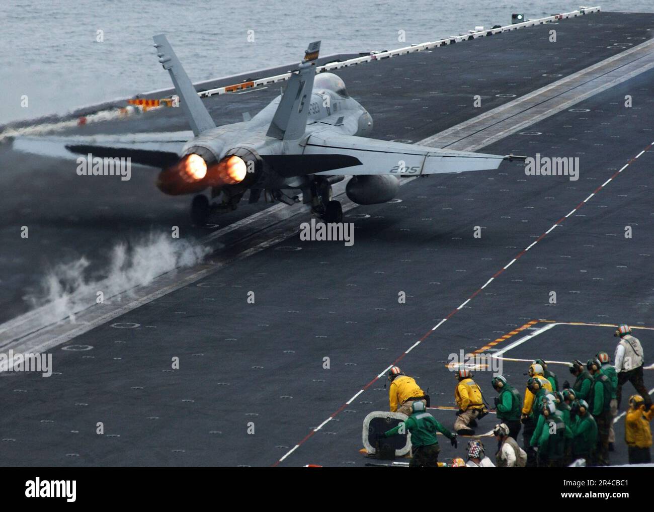 US Navy  An F-A-18C Hornet assigned to the Death Rattlers of Marine Fighter Attack Squadron Three Two Three (VMFA-323) launches from flight deck aboard the Nimitz-class aircraft carrier USS John C. Stennis (CV. Stock Photo