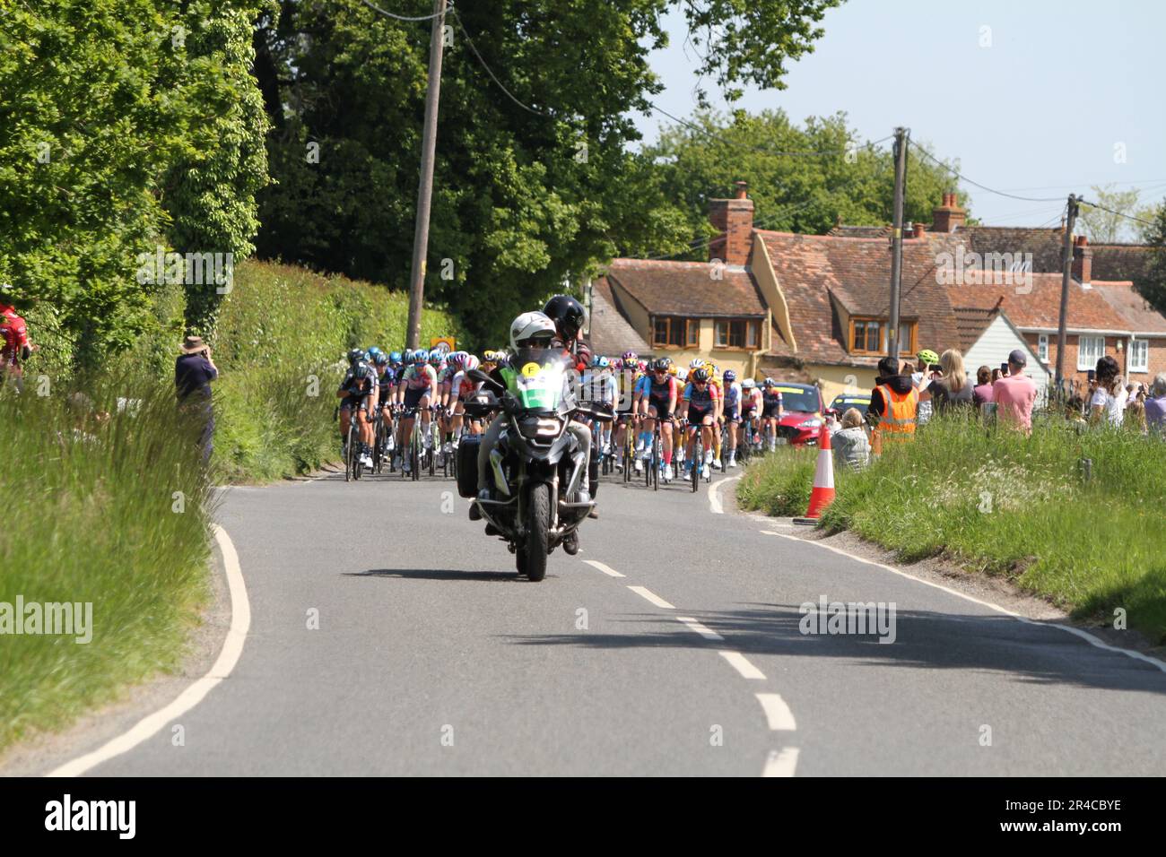Layer-de-la-Haye, UK. 27th May 2023. Stage 2 of the RideLondon Classique is taking place today. The stage begins and ends in Maldon with the route taking in the Essex countryside nearby. Here the riders are passing through the village of Layer-de-la-Haye near Colchester. Credit:Eastern Views/Alamy Live News Stock Photo