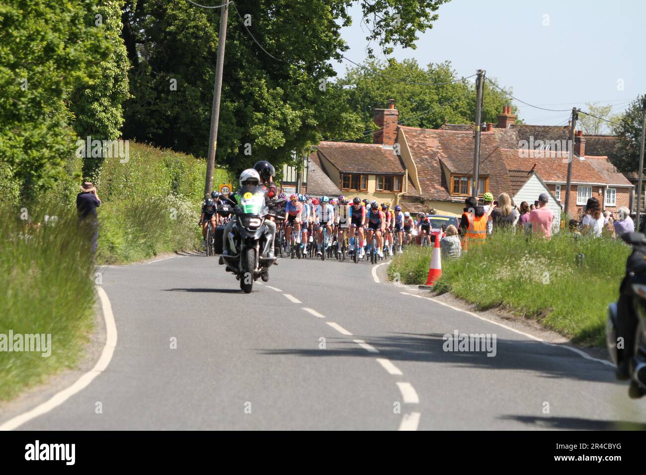 Layer-de-la-Haye, UK. 27th May 2023. Stage 2 of the RideLondon Classique is taking place today. The stage begins and ends in Maldon with the route taking in the Essex countryside nearby. Here the riders are passing through the village of Layer-de-la-Haye near Colchester. Credit:Eastern Views/Alamy Live News Stock Photo