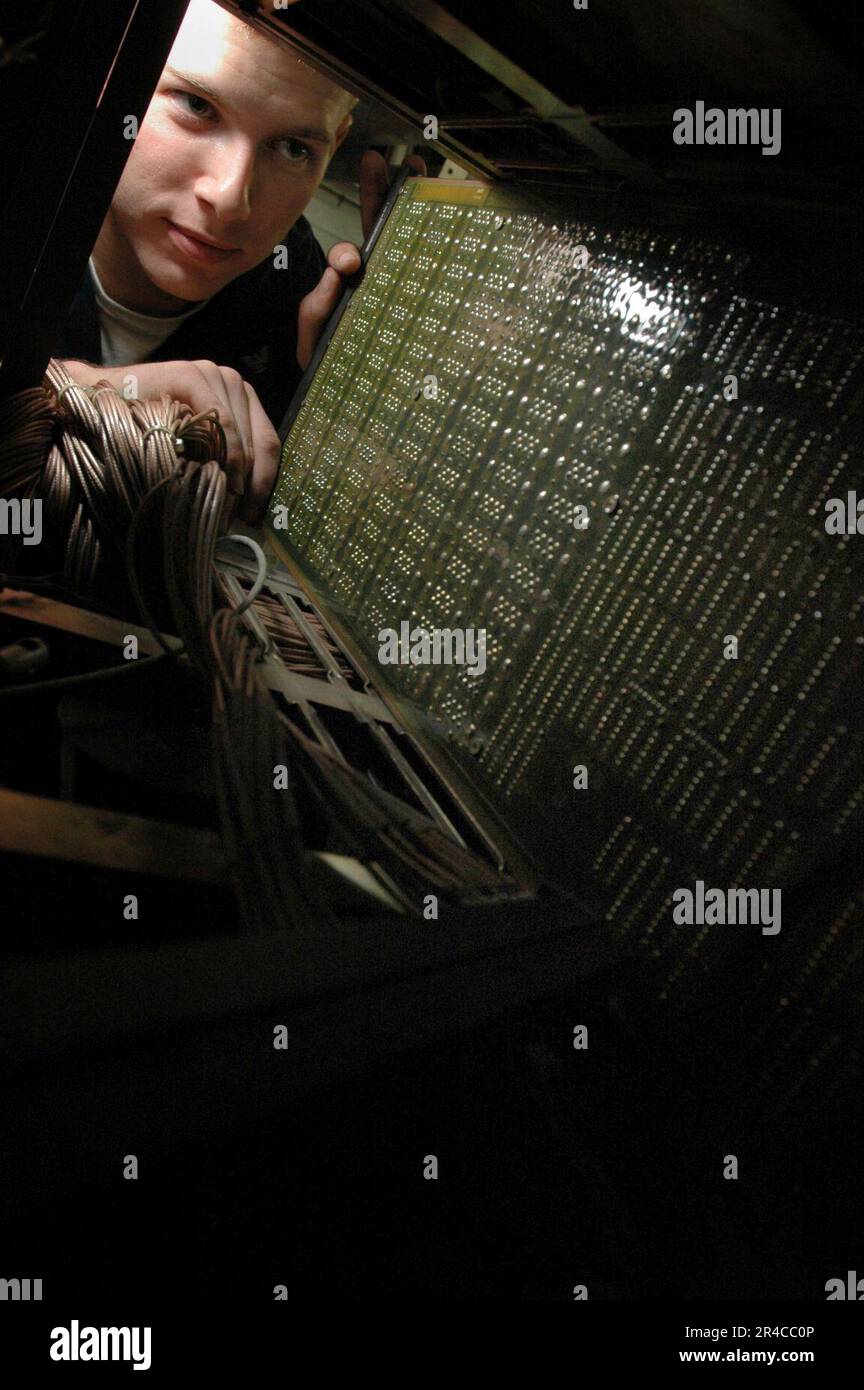 US Navy Aviation Electronics Technician 3rd Class inserts a circuit