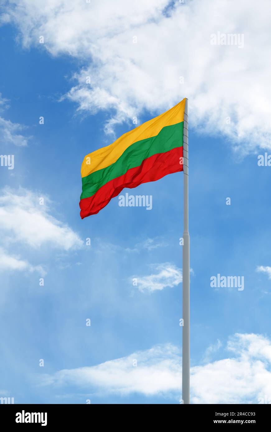 Flag of Lithuania is waving in front of blue sky and clouds Stock Photo