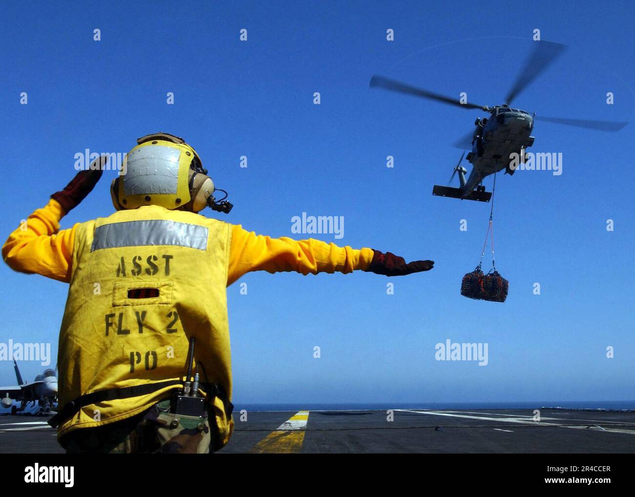 US Navy Aviation Boatswain's Mate Handling 2nd Class directs an SH60