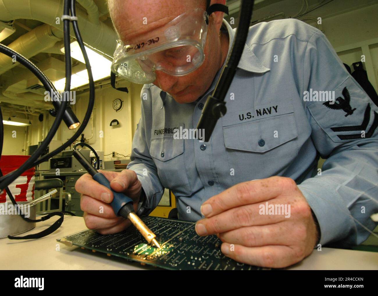 US Navy Aviation Electronics Technician 2nd Class performs maintenance