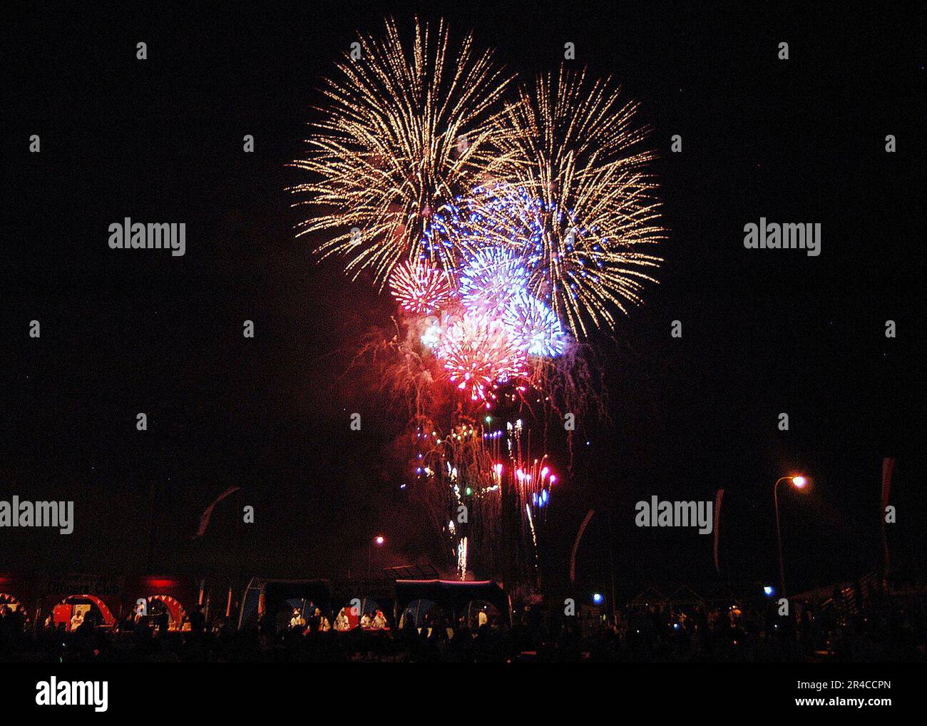 US Navy Sailors, family members and friends watch the fireworks display ...