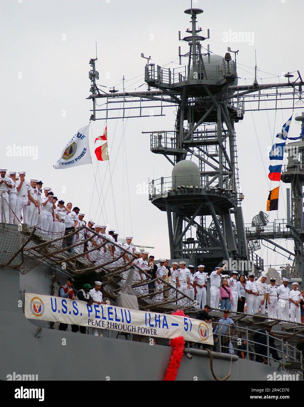 US Navy Sailors man the rails as the amphibious assault ship USS ...