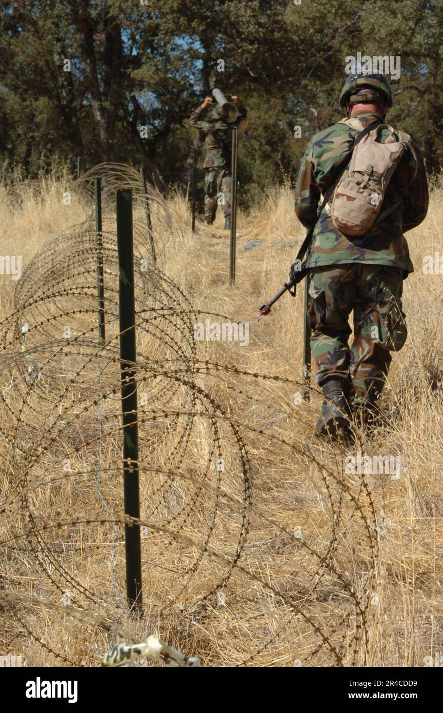 US Navy Builder Constructionmen walks along the security perimeter of the camps Logistics
