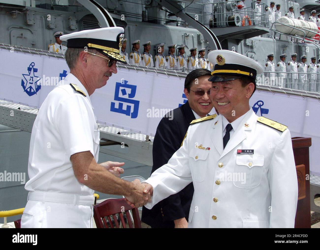 US Navy  Commander, Navy Region Hawaii, Rear Adm. T. G. Alexander greets Deputy Commander, North Sea Fleet, Rear Adm. Wang Fushan following the arrival of two ships representing China's Navy. Stock Photo