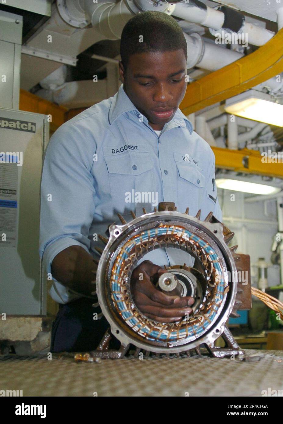 US Navy Electrician's Mate 3rd Class reassembles a ventilation motor aboard the Nimitzclass