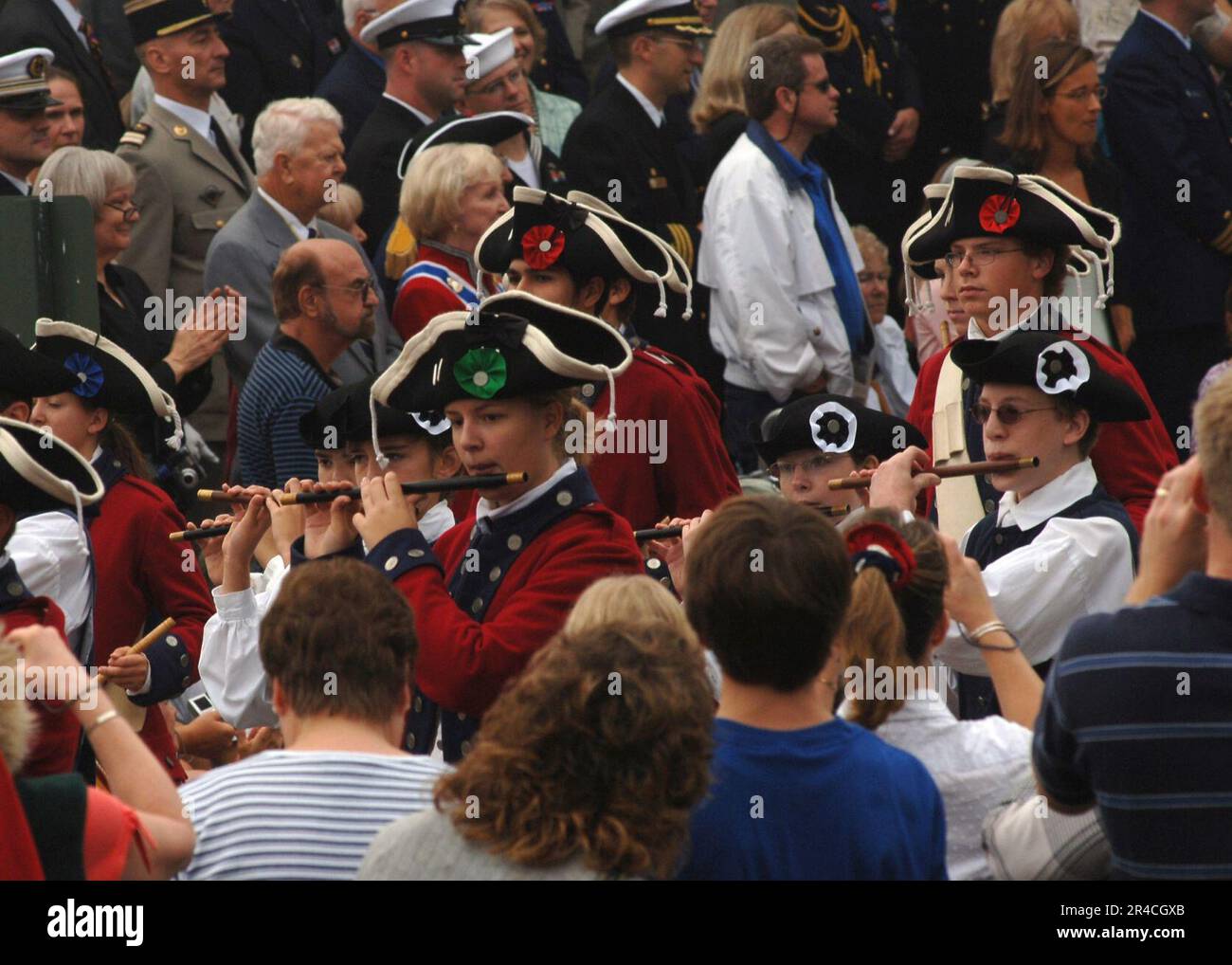 US Navy Fife and drum teams perform for a crowd of onlookers during the