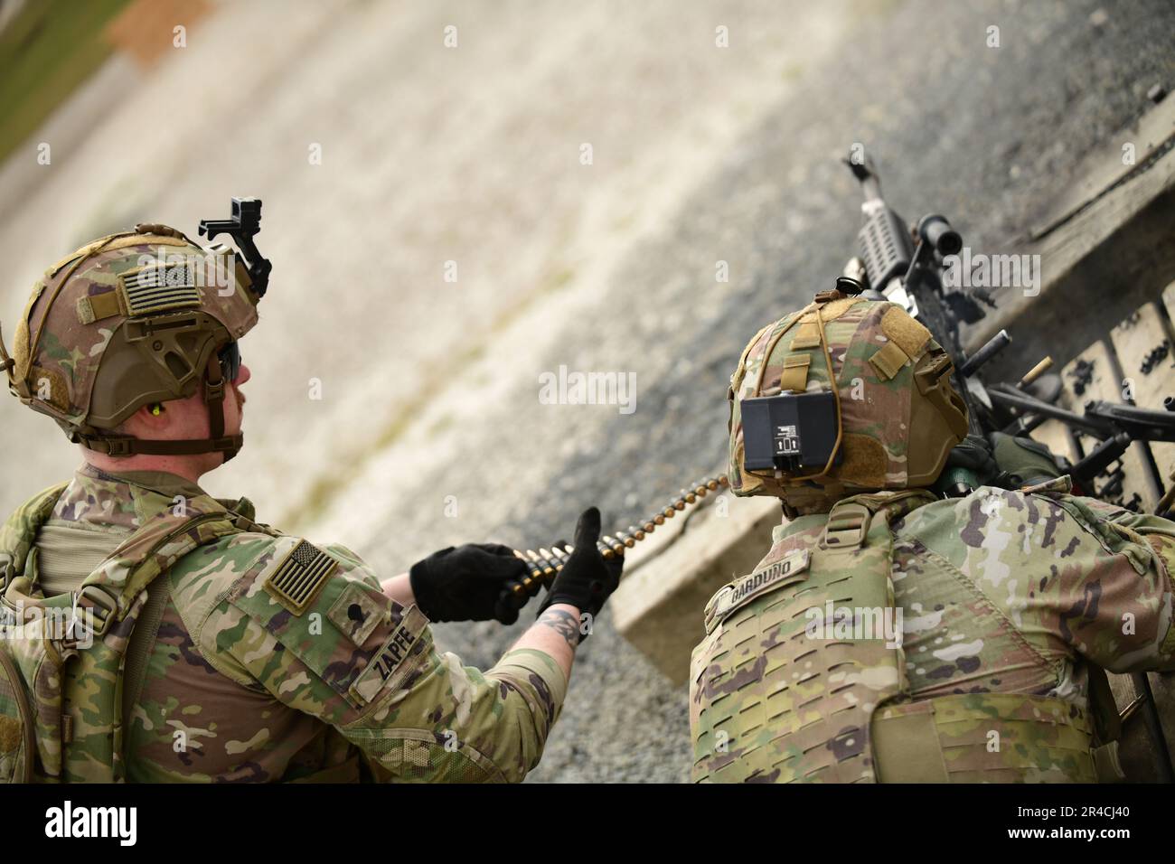 U.S. Army Spc. Benjamin Zapfe acts as assistant gunner for SFC Jeremy