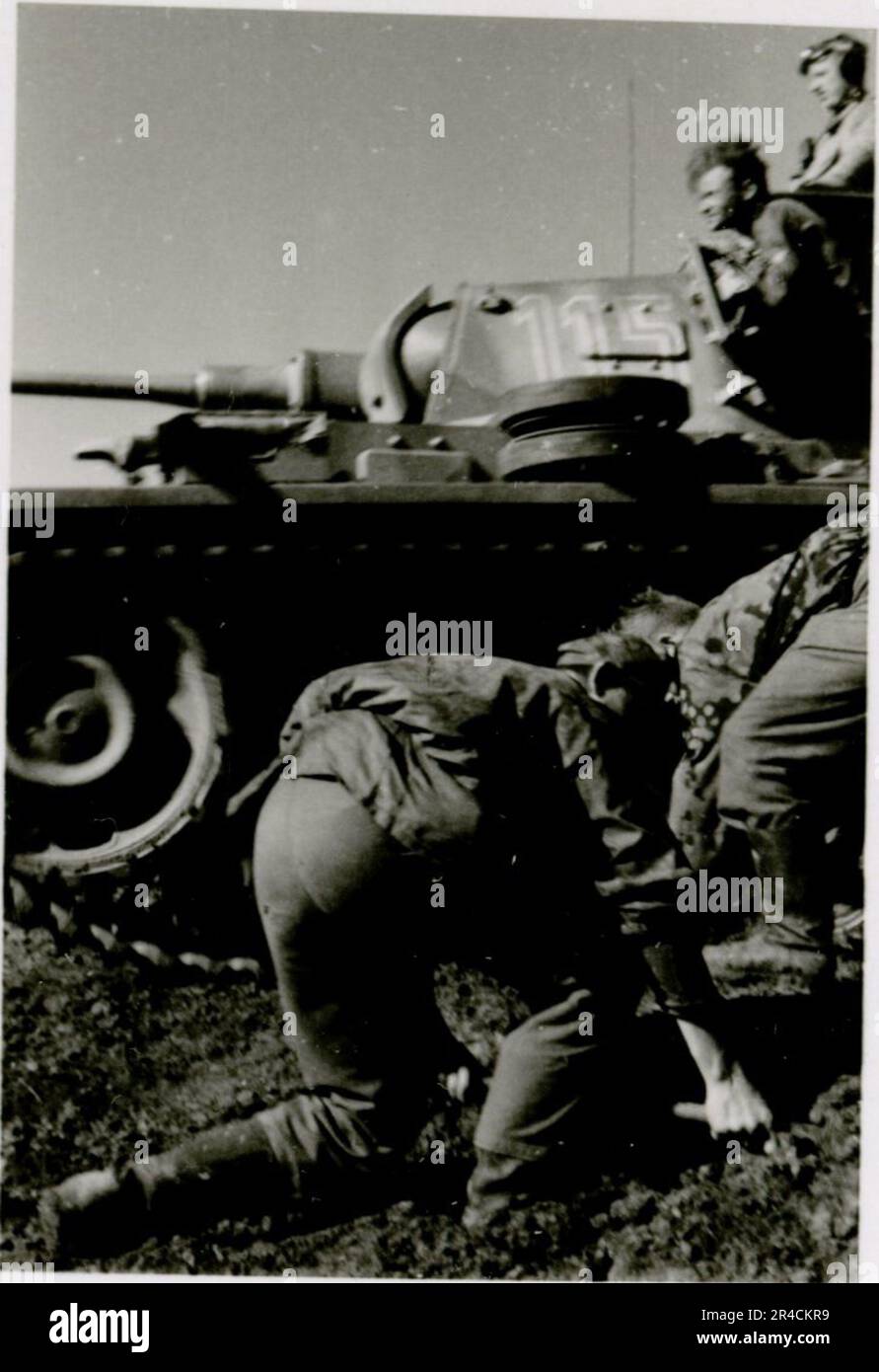 SS Photographer Willi Altstadt, Wiking Division, Russia 1942.  Rostov area village scenes, a Panzer III (with unit symbols) and panzer grenadiers on the steppe, combat scenes along a river, close-ups of infantry in the field with individual and crew-served weapons, a river crossing (assault and pontoon rafts), construction of a road block, Russian prisoners of war, SS-soldiers fishing and swimming, unit awards ceremony, observation post overlooking a river, and heavy artillery crew with howitzer. Images depicting the front-line activities of Waffen-SS units on the Western and Eastern Fronts, i Stock Photo