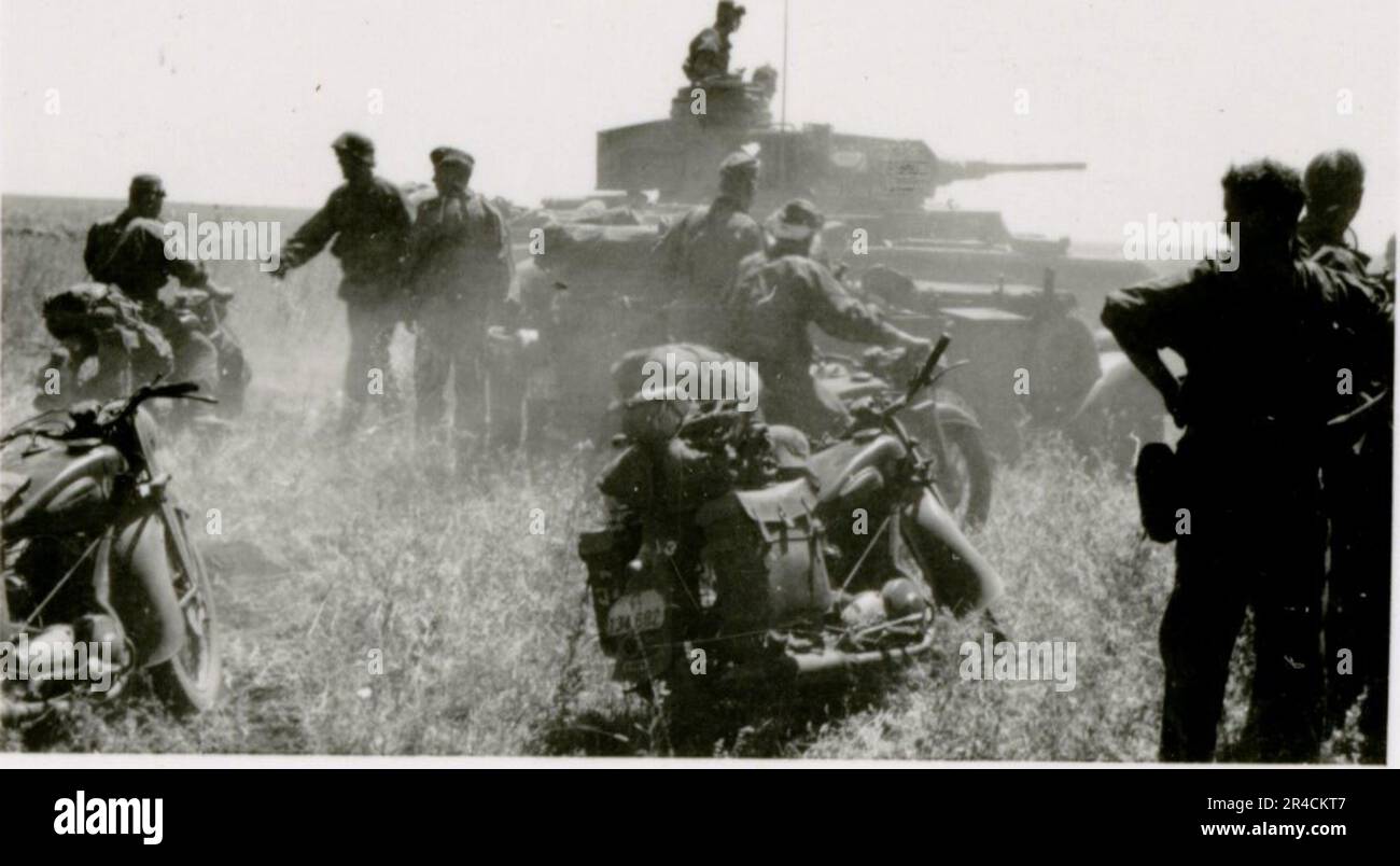 SS Photographer Willi Altstadt, Wiking Division, Russia 1942.  Rostov area village scenes, a Panzer III (with unit symbols) and panzer grenadiers on the steppe, combat scenes along a river, close-ups of infantry in the field with individual and crew-served weapons, a river crossing (assault and pontoon rafts), construction of a road block, Russian prisoners of war, SS-soldiers fishing and swimming, unit awards ceremony, observation post overlooking a river, and heavy artillery crew with howitzer. Images depicting the front-line activities of Waffen-SS units on the Western and Eastern Fronts, i Stock Photo