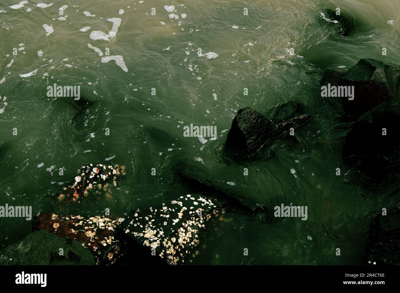 Rock submerged in sea water Stock Photo - Alamy